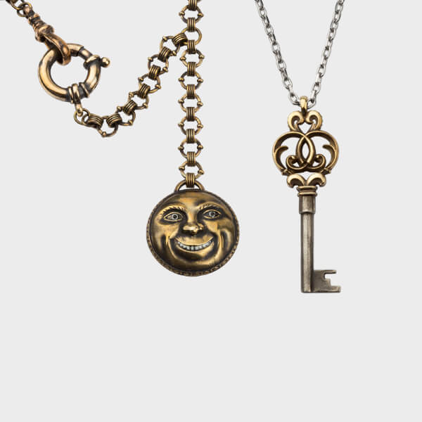 A bespoke face fob on a handmade chain and a key pendant necklace.